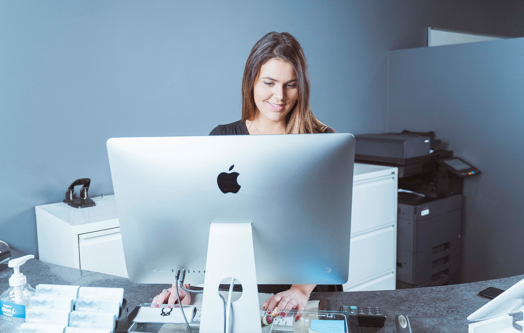 gabrielle working behind apple desktop computer